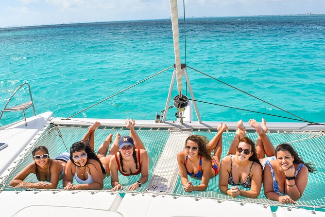 Isla Mujeres Catamaran Tour with Snorkel, Open bar and Transport - Returning by catamaran at sunset